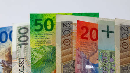 Swiss and Polish money. Banknotes of the Polish zloty and Swiss franc were placed next to each other and now constitute the background for many different financial matters. PLN and CHF currenciesの写真素材