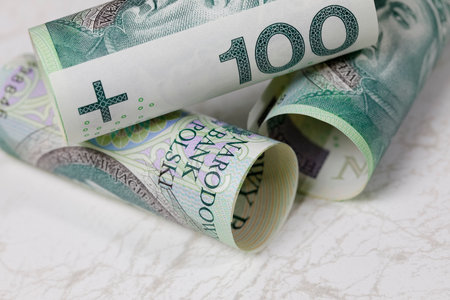 A pile of Polish zloty banknotes placed on a marble background, constituting the background for financial matters. PLN currency.の写真素材
