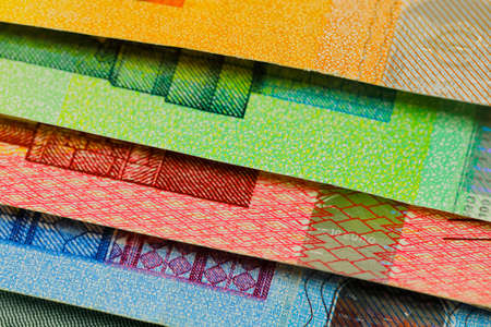 There are European Union banknotes placed next to each other. Euro banknotes are not made of paper, but of pure cotton fiber to improve their durability. EUR currency.の写真素材