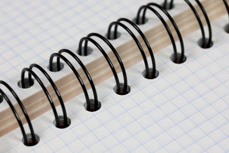 One checkered school notebook is open and no notes on its pagesの写真素材