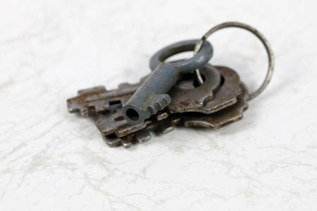 The old keys used for the old padlocks are shown against the marble background.の写真素材