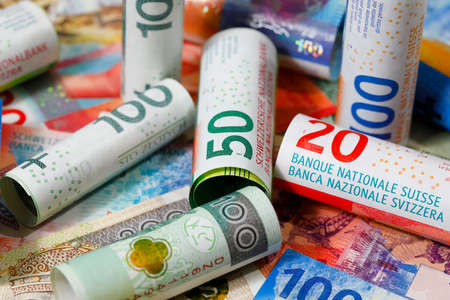 Swiss and Polish money. Banknotes of the Polish zloty and Swiss franc were placed next to each other and are now the backdrop to many different financial matters. PLN and CHF currenciesの写真素材