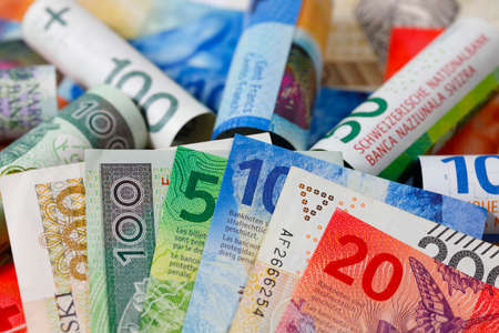 Swiss and Polish money. Banknotes of the Polish zloty and Swiss franc were placed next to each other and are now the backdrop to many different financial matters. PLN and CHF currenciesの写真素材