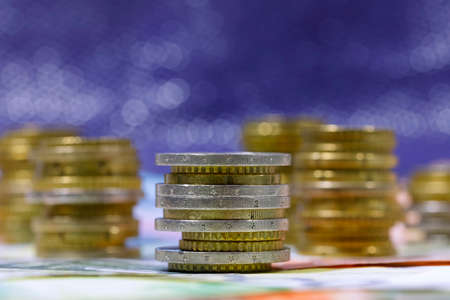 Group of Euro coins stacked side by side against a dark background, EUR currencyの写真素材