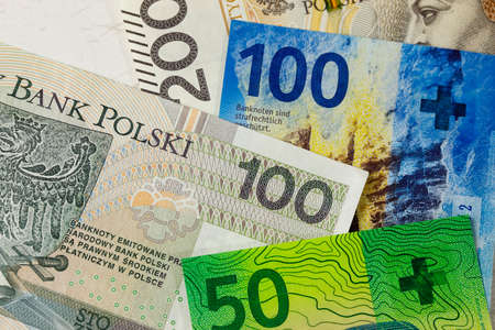Swiss and Polish money. Banknotes of the Polish zloty and Swiss franc were placed next to each other and now constitute the background for many different financial matters. PLN and CHF currenciesの写真素材