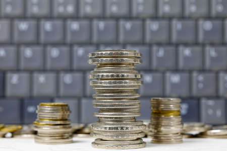 Swiss money. Coins of Swiss francs were placed against a computer keyboard background. CHF currencyの写真素材