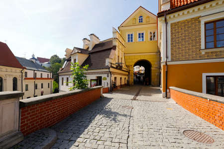 Lublin, Poland - September 11, 2021: A paved walkway leads towards the city gate and buildings. There are only a few people here admiring the architecture of this historic cityのeditorial素材