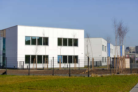 Warsaw, Poland - March 1, 2022: A modern school buildings complex. It is a new place for the education of children and youth in the Goclaw housing estate, in the Praga Poludnie district.のeditorial素材