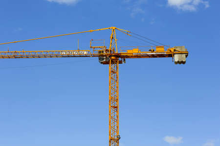 Warsaw, Poland - April 18, 2022: A fragment of a tall construction crane on the construction site of...