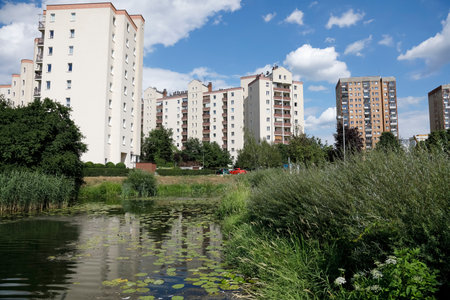 Warsaw, Poland - July 7, 2022: Multi-storey residential buildings in the Goclaw housing estate, in the Praga Poludnie district of the city of Warsaw. There is a public park with a lake.のeditorial素材