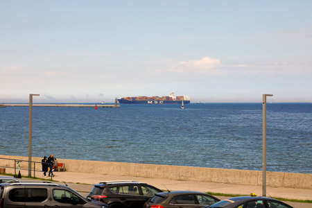 Gdynia, Poland - May 30, 2022: In the distance, you can see a container ship entering the port of Gdynia in the Gdansk Bay on the Baltic Seaのeditorial素材