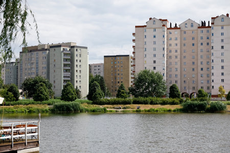 Warsaw, Poland - July 7, 2022: Multi-storey residential buildings in the Goclaw housing estate, in the Praga Poludnie district of the city of Warsaw. There is a public park with a lake.のeditorial素材