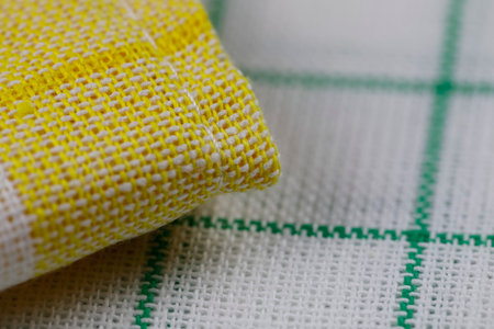A group of new, unused colored napkins or kitchen towels for daily home use in the kitchen or on a picnic. These little napkins are arranged in a small pileの写真素材