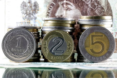 These are Polish zloty coins, with Polish paper money in the background. This image provides illustrations for many various financial matters. PLN currencyの写真素材
