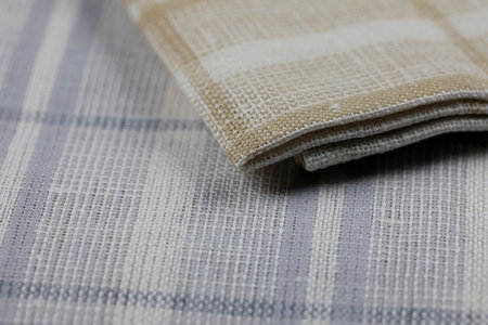 A group of new, unused colored napkins or kitchen towels for daily home use in the kitchen or on a picnic. These little napkins are arranged in a small pileの写真素材