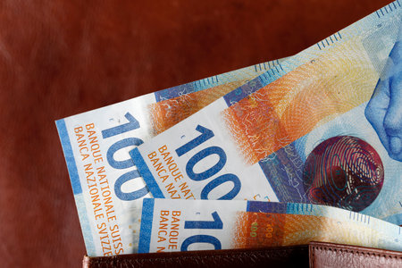 The bills slid out of the wallet. Swiss franc notes can be used as illustrations for various financial topics. CHF paper money, edition of Swiss banknotes, issued from April 2016 to 2019.の写真素材