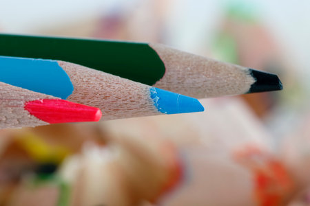 Three colored pencils, each of a different color, are shown close up hereの写真素材