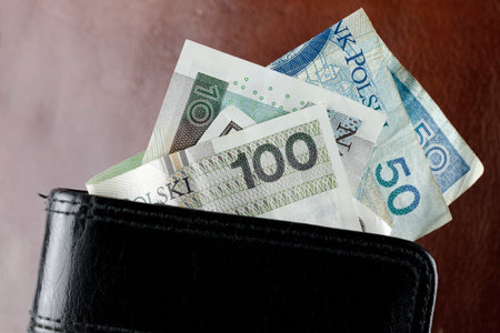 Polish money. Polish zloty banknotes slid out of the wallet. Such an image can be used as an illustration for many various financial issues. PLN currency.の写真素材