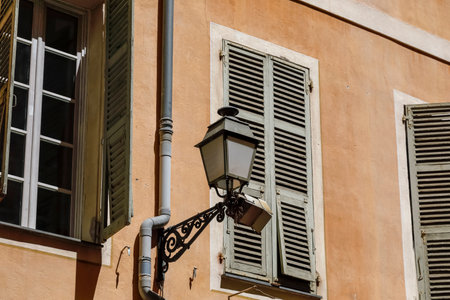 A street lamp has been installed on the facade of a building in the old town of Nice, Franceの写真素材