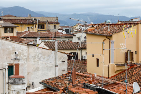 The roofs of historic houses somewhere in the old town of Florence, Italy have been covered with ceramic tilesの写真素材