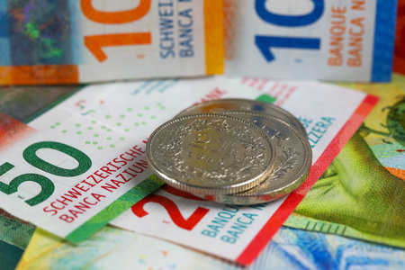 The Swiss currency, CHF, is visible. Coins are shown lying on paper money. It can be used to illustrate a wide range of financial topics.の写真素材