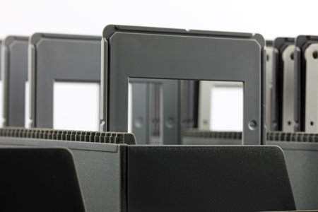 A few diapositive frames are stacked in a tray designed to be used for slide shows with a projector.の写真素材