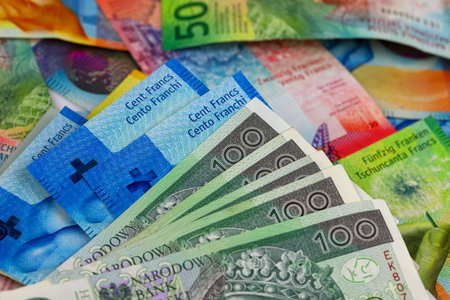 Polish and Swiss money. Polish zloty banknotes next to Swiss banknotes. This theme can be used to illustrate many different financial topics. PLN and CHF currencies.の写真素材