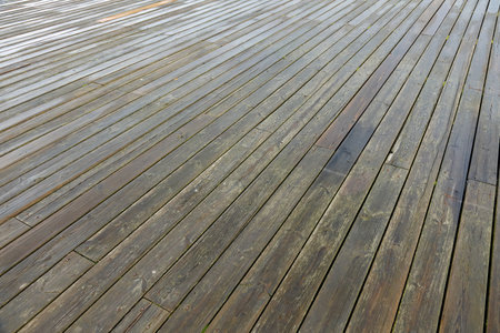 Fragment of a pier on the Baltic coast in Sopot, Poland. This view of the wooden pier floor can be used as a wooden background.の写真素材