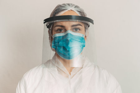 female doctor health care worker with face mask and shield