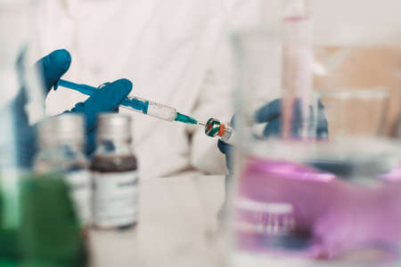 scientist hands holding vaccine in lab