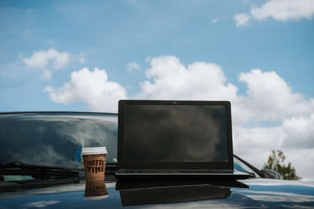 outdoors laptop with coffee cup, remote location in nature with beautiful mountains internet connection, freelancer freedomの写真素材