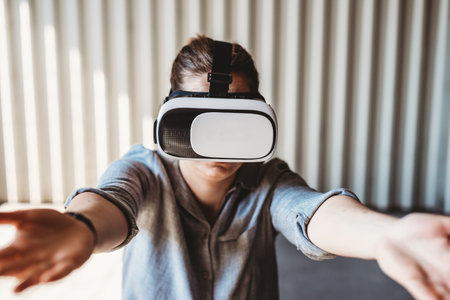 woman with vr goggles and facial expression enjoying virtual reality experienceの写真素材