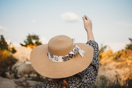 woman with summer hat looking at the  lake