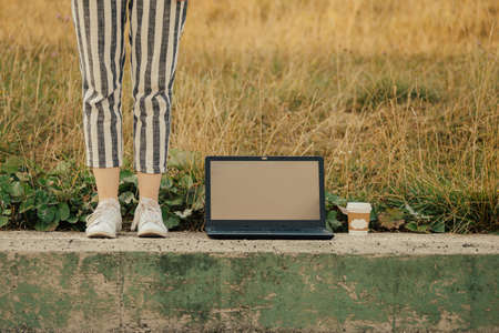 freelancer concept with laptop and coffee cup outdoorsの写真素材