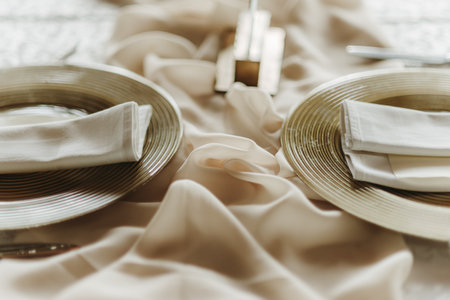 Table set for wedding or another catered event dinner. Decorated with white tablecloth and napkins.の写真素材