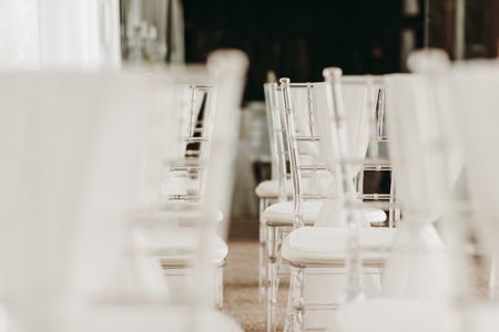 White chairs and tables at a wedding reception. Selective focus.