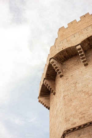 Ancient stone fortress tower with detailed architecture against a cloudy skyの写真素材