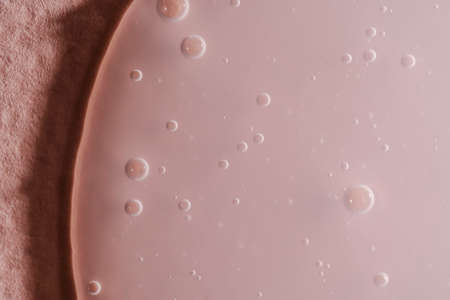 A drop of shampoo on a pink background.の写真素材