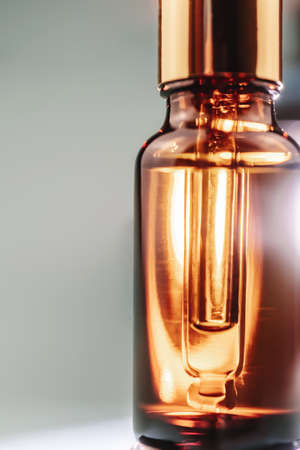 Pipette with cosmetic oil in a brown bottle with bubblesの写真素材