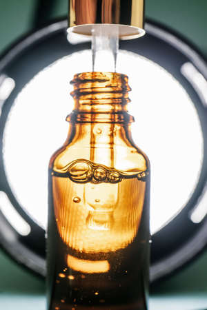 Pipette with cosmetic oil in a brown bottle with bubblesの写真素材