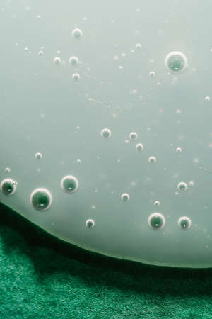 A drop of shampoo on a green backgroundの写真素材