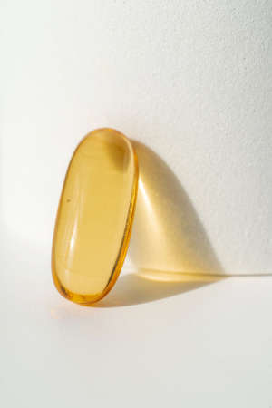 Oil filled capsules on the white backgroundの写真素材