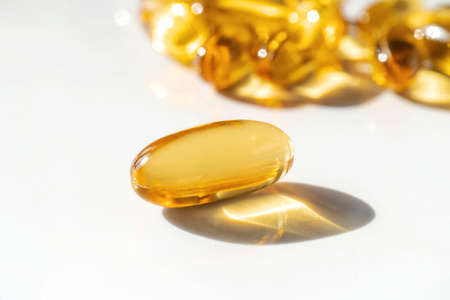 Oil filled capsules on the white backgroundの写真素材