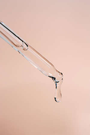 A drop of cosmetic oil falls from the pipetteの写真素材