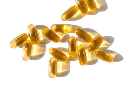 Oil filled capsules on the white backgroundの写真素材