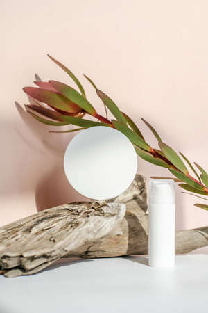 The serum and cream stand on a piece of wood.の写真素材