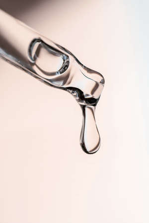 A drop of cosmetic oil falls from the pipetteの写真素材
