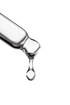 A drop of cosmetic oil falls from the pipetteの写真素材