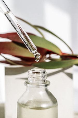 A drop of cosmetic oil falls from the pipetteの写真素材