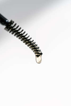 A drop of oil for eyebrows and eyelashes falls from the brushの写真素材